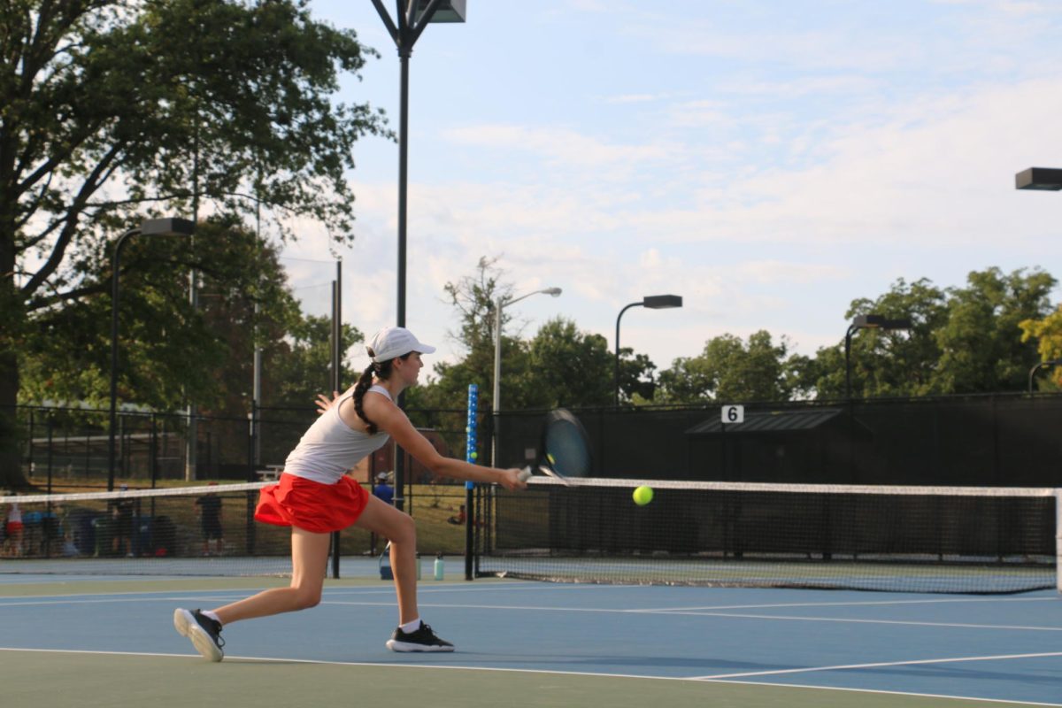 Tori Haroutounian slices the ball at the Girls' Varsity tennis match. As a freshman on varsity, Haroutounian had doubts about playing for a team instead of individual tournaments; however, she has found the environment extremely supportive. “I really love the girl’s tennis team,” Haroutounian said. “It is such a different experience than just playing tournaments, because everybody is cheering each other on and being so supportive.”