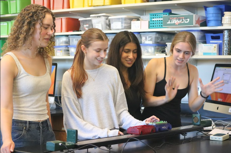 Isabela MoronCousins, Eva Baxter, Gasya Berberian and Claire Graetz observe elastic and inelastic collisions in an AP Physics lab. Berberian's favorite topics this semester were the circular motion and gravitational force between planets. “One of my most memorable moments from this class, so far, was when our unit three exam got pushed back by a few days. It would've been our third exam in a three-week time period,” Berberian said. “When we all heard the news, the class applauded and cheered.”