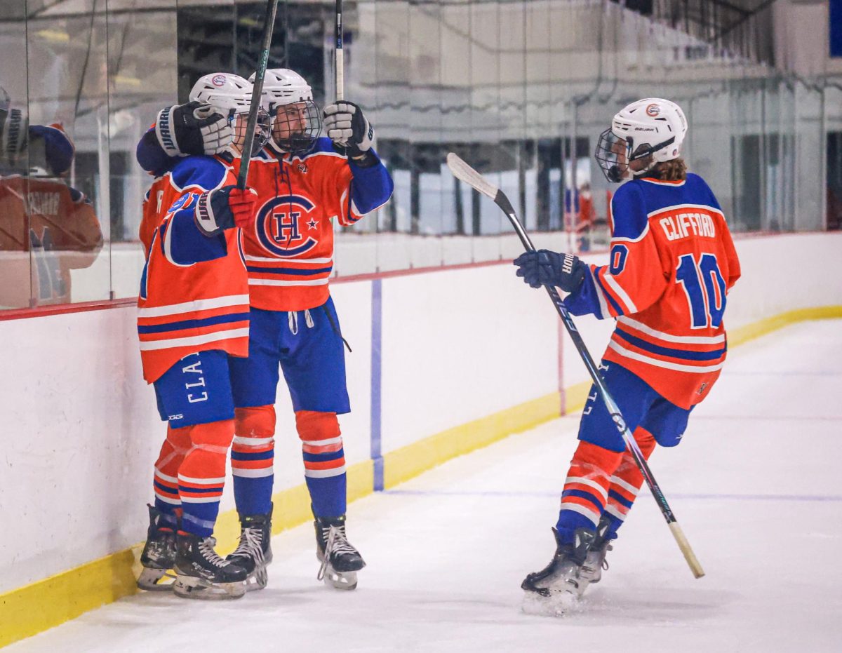 After making a goal against the Ladue High School hockey team, sophomore Silas Bilhorn celebrates with his teammates Christopher Springer and Daniel Clifford. Clayton beat Ladue 3-1.
