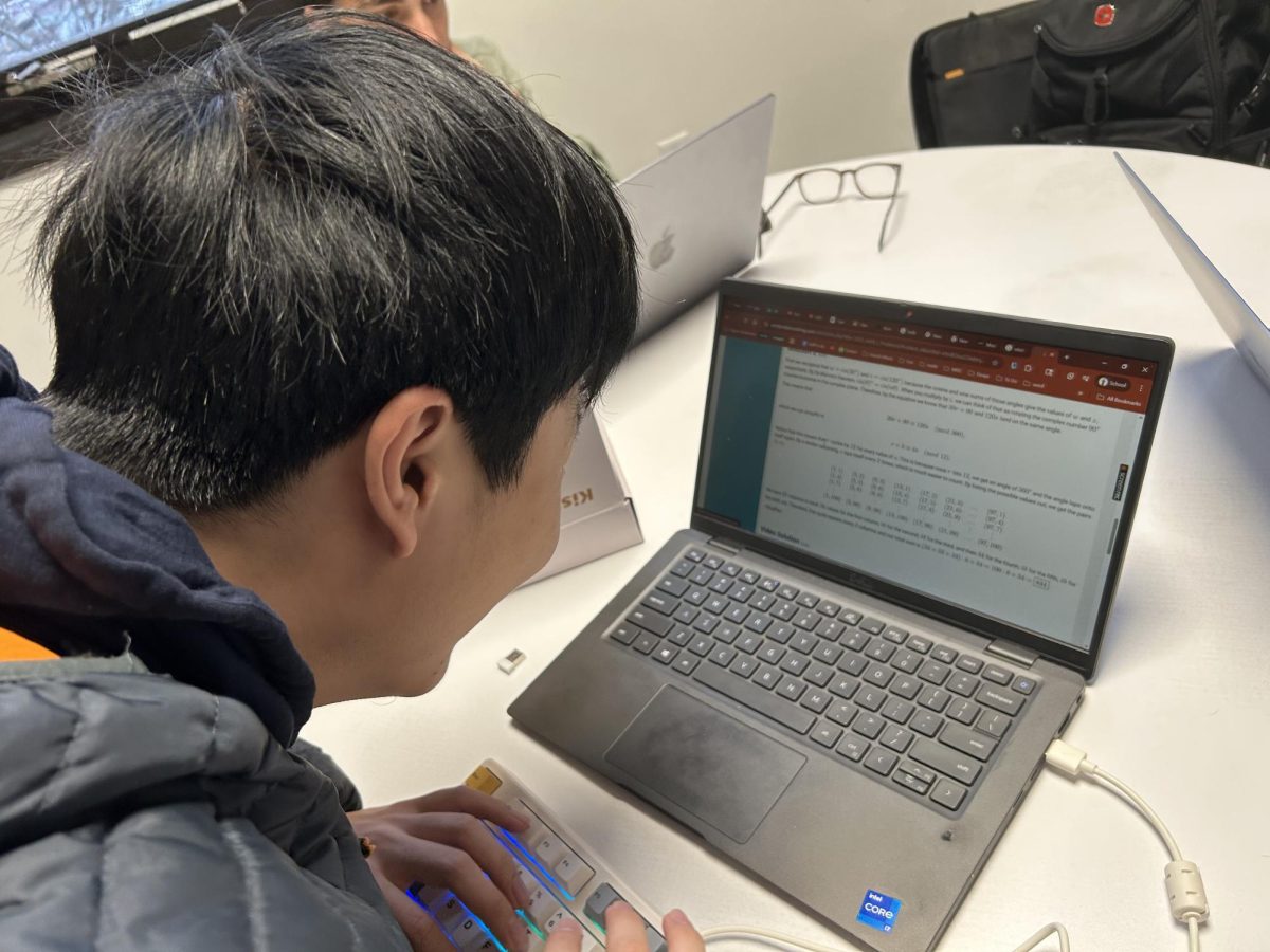 Senior Yijia Mao working on an AIME problem to prepare himself for this year's competition with his classmates. 