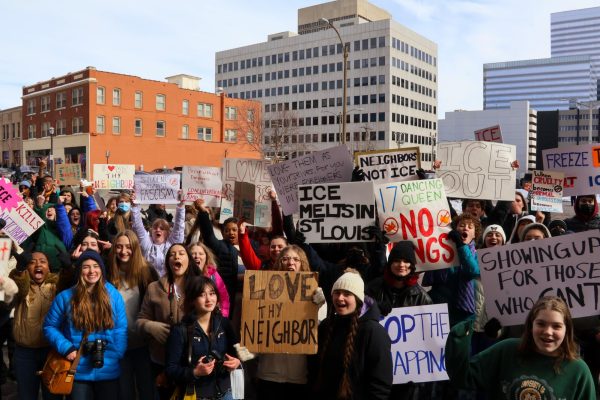 Demonstrators protest in 11°F temperatures against the immigration crackdown. They marched outside the main entrance of the school to the St. Louis County Courthouse. Students began gathering outside the school at 9:35 a.m. for the National Day of Action.