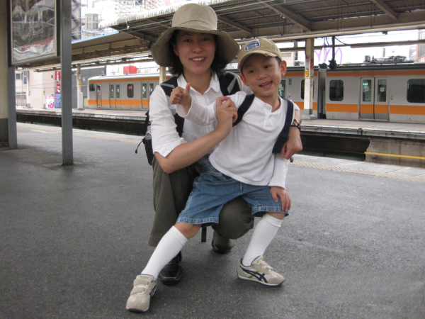 A 4-year-old Magnus stands with his mother at a subway station in Haneda International Airport, on his journey from Japan to the United States.