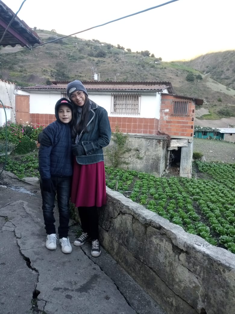 While on a mission trip, freshman Kendry Rodriguez poses for a picture with his aunt in front of a house in Mérida, Venezuela.