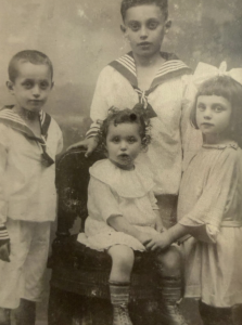 The Neumann family picture shows older brothers Kurt Neumann (standing on the left) and Marcel Neumann (standing in the back), Gerti Neumann (Zoe Shook’s great-grandmother, standing on the right) and her younger sister Meta Neumann (seated).  (Photo courtesy of Jeremy Shook)