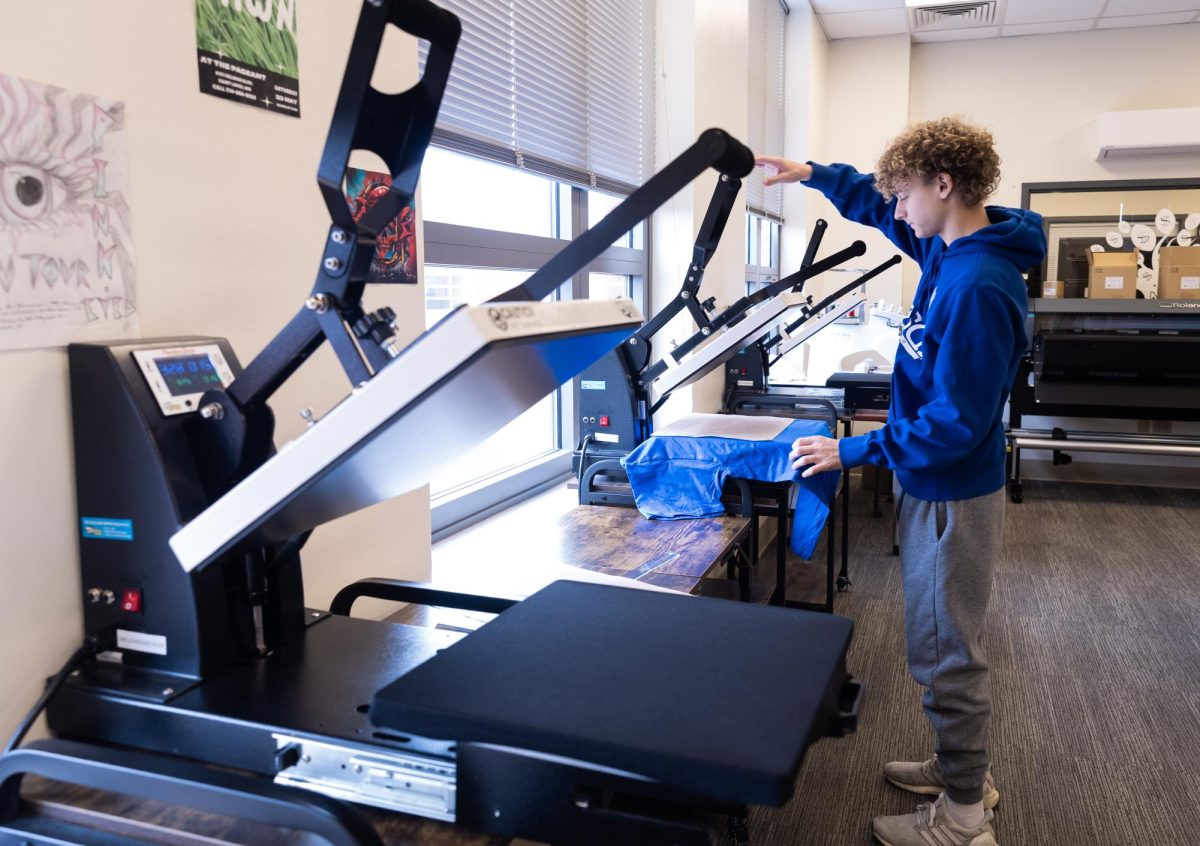 Putting shirts on the press to add Captain elementary school alumni print on the shirt. Freshman Birk Hoette is the newest addition to the Greyhound Threads shop.