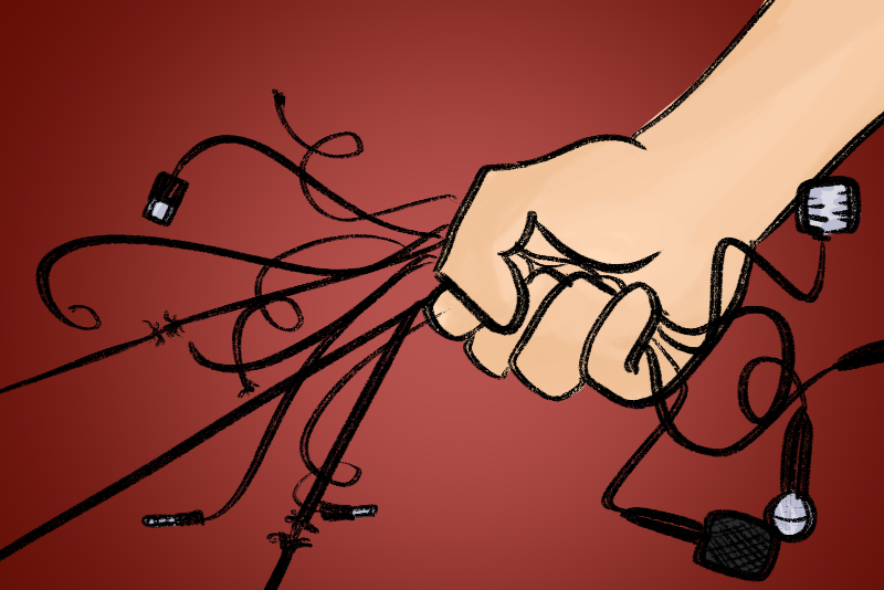 A hand ripping the cords to connect to microphones that represent the free speech of Americans.