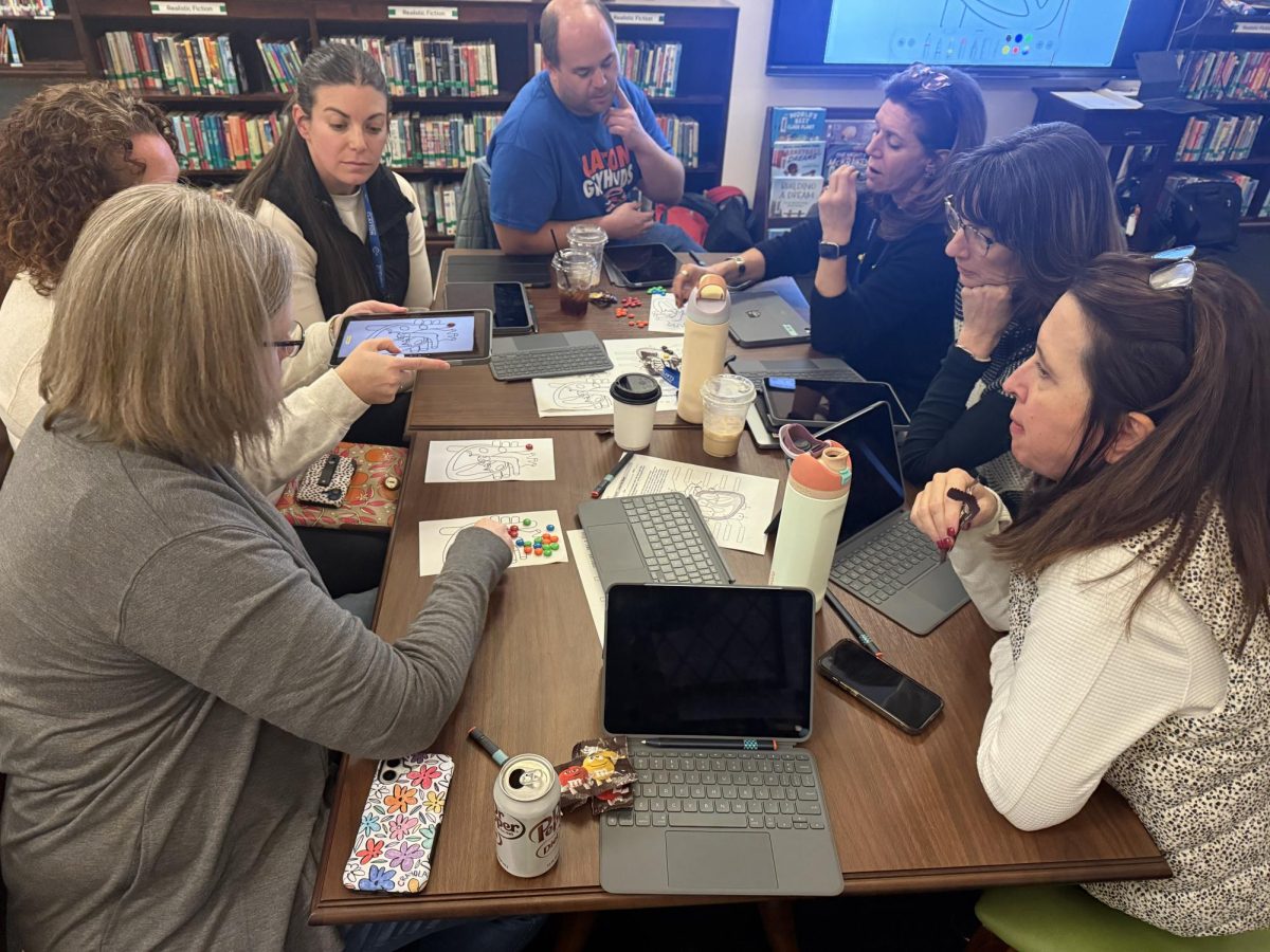 Teachers come together for a hands-on session to test iPads paired with keyboard cases and evaluate how the technology might enhance their classrooms.