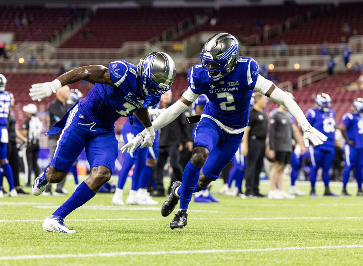 Two St. Louis Battlehawks players prepare for their regular season finale against the Dallas Renegades. The Battlehawks lost 20-16. 