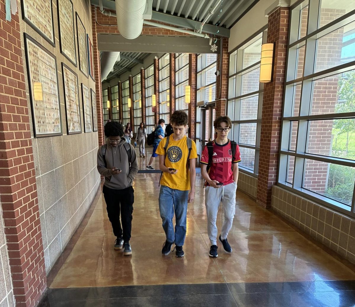 Juniors Aningo Aningo, Henry Dupor and Michael Evra walk toward the Center of Clayton to avoid the school's phone ban.
